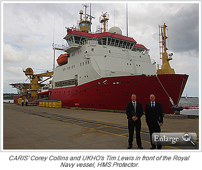 CARIS’ Corey Collins and UKHO’s Tim Lewis in front of the Royal Navy vessel, HMS Protector.